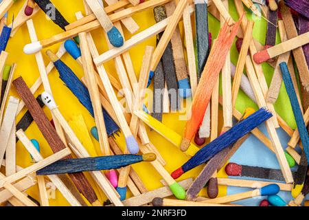 matchsticks of various shapes and colors with multicolored paper sticky notes on background Stock Photo
