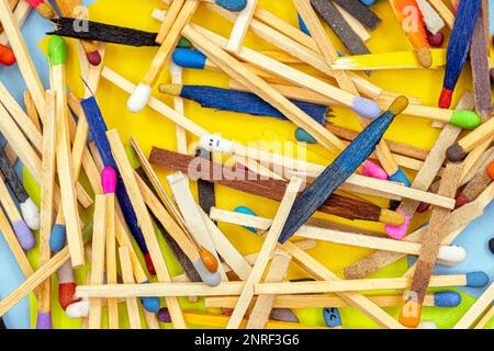 matchsticks of various shapes and colors with multicolored paper sticky notes on background Stock Photo