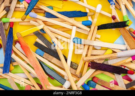 matchsticks of various shapes and colors with multicolored paper sticky notes on background Stock Photo
