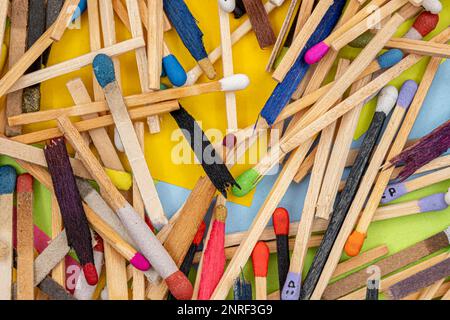 matchsticks of various shapes and colors with multicolored paper sticky notes on background Stock Photo