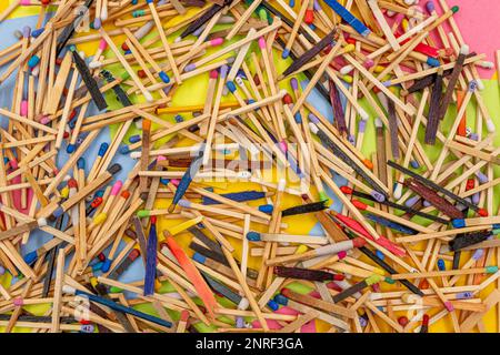matchsticks of various shapes and colors with multicolored paper sticky notes on background Stock Photo