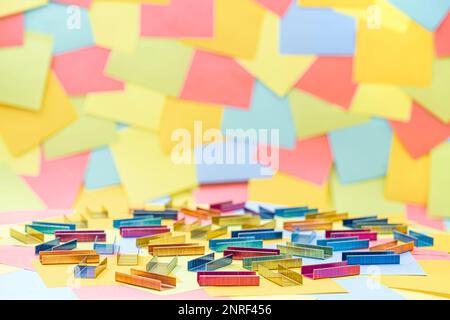 Multicolored office metal staples for stapler on multicolored paper Sticky Notes Stock Photo