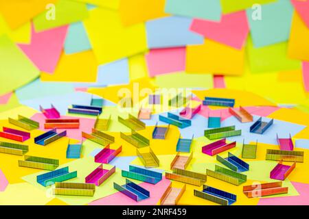 Multicolored office metal staples for stapler on multicolored paper Sticky Notes Stock Photo