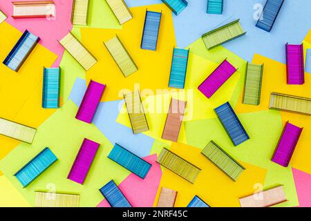 Multicolored office metal staples for stapler on multicolored paper Sticky Notes Stock Photo