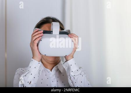 Young woman wearing VR glasses. Stock Photo