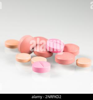 Pink pills, medicine isolated on white background, top view. Stock Photo