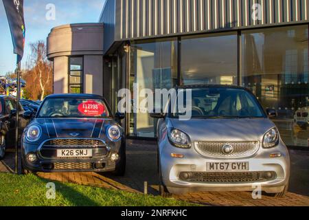For Sale Priced 2017 Grey MINI COOPER S 1998cc Petrol 6 speed automatic & 2018 Black SMART FORTWO 998cc Petrol 6 speed auto at Second hand car dealership at Preston Motor Park, Lancashire, UK Stock Photo