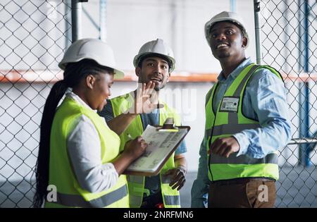 Safety always makes better sense. a group of builders inspecting a construction site. Stock Photo