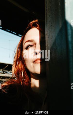 portrait of red-haired woman at sunset Stock Photo