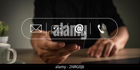 CONTACT US (Customer Support Hotline people CONNECT ) Businessman touching phone application check  email Stock Photo