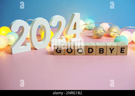 Goodbye 2024 word alphabet letters on wooden background Stock Photo