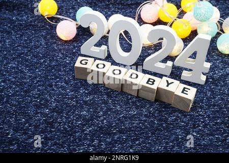 Goodbye 2024 alphabet letter decorate with LED cotton ball on blue knitted fabric background4 Stock Photo