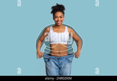 Foto de Millennial slim african american lady in big jeans, enjoy