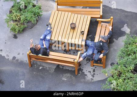 Balcony builders having a break in a backyard in Södermalm in Stockholm, Sweden. Picture was taking on september 28 2011. Stock Photo