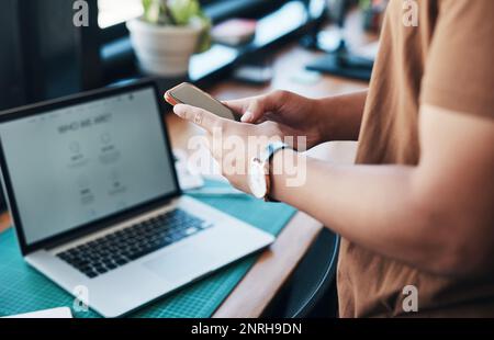 Checking my messages. an unrecognizable businessman using a cellphone in an office. Stock Photo