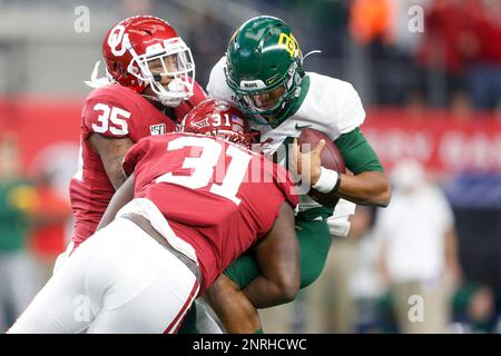 Oklahoma defensive tackle Jalen Redmond (31), defensive lineman Neville  Gallimore (90) and linebacker Nik Bonitto (35) celebrate Redmond's sack of  Baylor quarterback Gerry Bohanon during the second half of an NCAA college