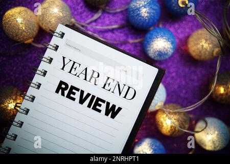 Year End Review text message on notepad background Stock Photo