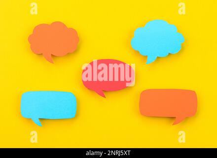 Speech bubbles arranged on a yellow background Stock Photo