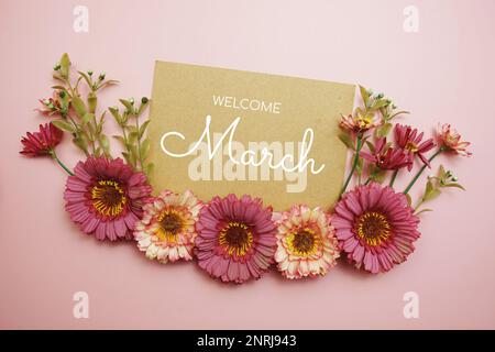 Welcome March typography text with flowers on pink background Stock Photo