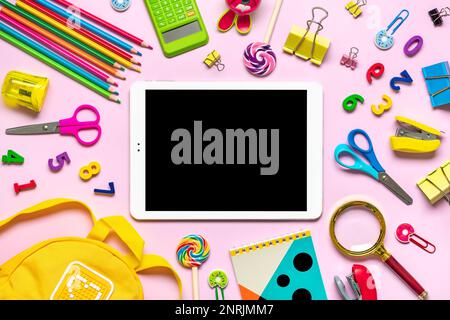 Back to school, education concept. School supplies Notebook, pens, ruler, calculator, backpack, scissors, tablet isolated on pink background Top view Copy space Flat lay composition Mock up School. Stock Photo