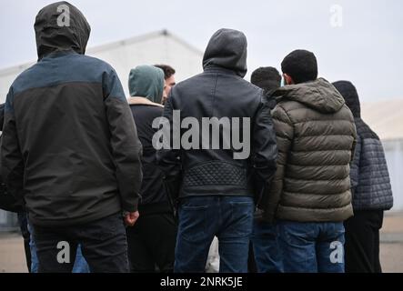 Bensheim, Germany. 10th Feb, 2023. War refugees from Syria stand together on the grounds of the refugee shelter. Cities and communities can hardly accommodate the number of refugees. The Bergstrasse district is not alone in calling for more support from the federal and state governments. Credit: Arne Dedert/dpa/Alamy Live News Stock Photo