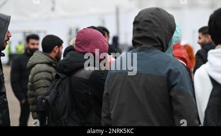 Bensheim, Germany. 10th Feb, 2023. War refugees from Syria stand together on the grounds of the refugee shelter. Cities and communities can hardly accommodate the number of refugees. The Bergstrasse district is not alone in calling for more support from the federal and state governments. Credit: Arne Dedert/dpa/Alamy Live News Stock Photo