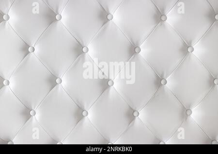 White luxurious diamond pattern leather upholstery with buttons. Background concept. Furniture sofa cover. Stock Photo