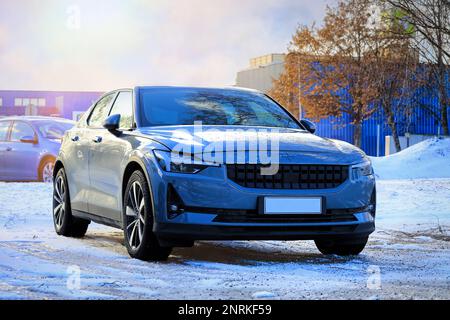 Polestar 2 electric car parked on yard in winter. The Polestar 2 is a battery electric 5-door liftback produced by Volvo under its Polestar sub-brand. Stock Photo