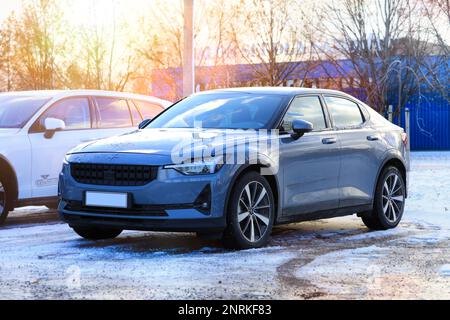 Polestar 2 electric car parked on yard in winter. The Polestar 2 is a battery electric 5-door liftback produced by Volvo under its Polestar sub-brand. Stock Photo