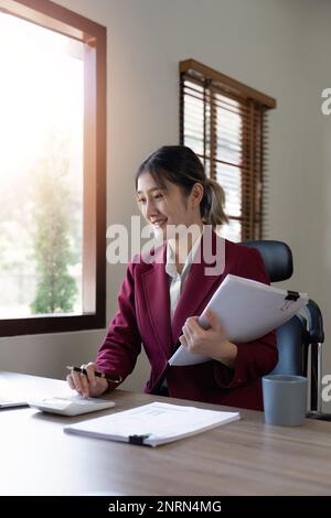 Businessman hands using text information on laptop to analyze financial statistical chart data and calculate cost of investment project Stock Photo