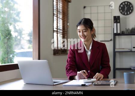 Businessman hands using text information on laptop to analyze financial statistical chart data and calculate cost of investment project Stock Photo