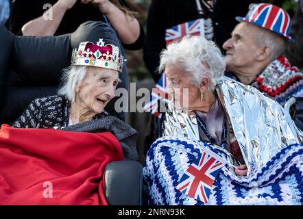 Residents Winifred Bennett, aged 101, left, and Doris Lyford, aged 98, wait for the arrival of Britain's Queen Elizabeth II at the Royal British Legion Industries village in Aylesford, south east England, Wednesday Nov. 6, 2019, to celebrate the charity's centenary year. (Richard Pohle/Pool via AP)