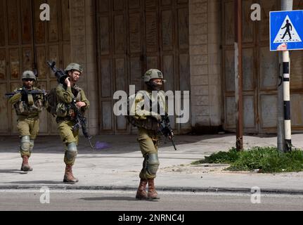 Hawara, Gaza. 27th Feb, 2023. Israeli soldiers patrol in the Palestinian town of Hawara, the morning after Jewish settlers burned cars and houses in revenge for two Israeli brothers killed yesterday by a Palestinian gunman in the West Bank, on Monday, February 27, 2023. Photo by Debbie Hill/ Credit: UPI/Alamy Live News Stock Photo