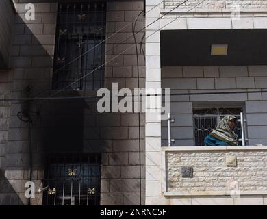 Hawara, Gaza. 27th Feb, 2023. A Palestinian woman stands outside her apartment burned by Israeli settlers in a revenge attack after two Israeli brothers were killed yesterday by a Palestinian gunman in Hawara, in the West Bank, on Monday, February 27, 2023. Photo by Debbie Hill/ Credit: UPI/Alamy Live News Stock Photo