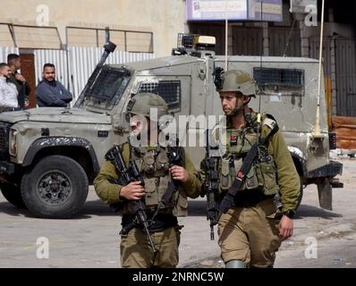 Hawara, Gaza. 27th Feb, 2023. Israeli soldiers patrol in the Palestinian town of Hawara, the morning after Jewish settlers burned cars and houses in revenge for two Israeli brothers killed yesterday by a Palestinian gunman in the West Bank, on Monday, February 27, 2023. Photo by Debbie Hill/ Credit: UPI/Alamy Live News Stock Photo