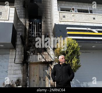 Hawara, Gaza. 27th Feb, 2023. A Palestinian stands outside a house burned by Israeli settlers in a revenge attack after two Israeli brothers were killed yesterday by a Palestinian gunman in Hawara, in the West Bank, on Monday, February 27, 2023. Photo by Debbie Hill/ Credit: UPI/Alamy Live News Stock Photo