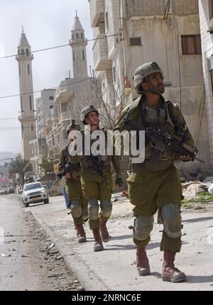 Hawara, Gaza. 27th Feb, 2023. Israeli soldiers patrol in the Palestinian town of Hawara, the morning after Jewish settlers burned cars and houses in revenge for two Israeli brothers killed yesterday by a Palestinian gunman in the West Bank, on Monday, February 27, 2023. Photo by Debbie Hill/ Credit: UPI/Alamy Live News Stock Photo