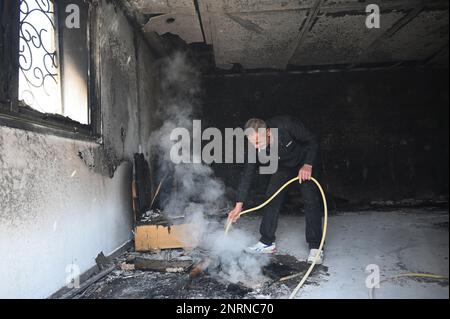 Hawara, Gaza. 27th Feb, 2023. A Palestinian stands inside a house burned by Israeli settlers in a revenge attack after two Israeli brothers were killed yesterday by a Palestinian gunman in Hawara, in the West Bank, on Monday, February 27, 2023. Photo by Debbie Hill/ Credit: UPI/Alamy Live News Stock Photo