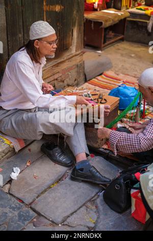 Kathmandu, Nepal, 04 23 2022: Webster knitting cloth with his feet Stock Photo