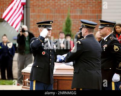 WASHINGTON, Aug. 14, 2014 -- Susan Myers presents a flower on the coffin of  her husband U.S. Army Maj. Gen. Harold Greene during a burial service at  section 60 of Arlington National