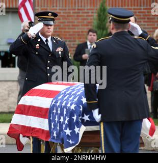 WASHINGTON, Aug. 14, 2014 -- Susan Myers presents a flower on the coffin of  her husband U.S. Army Maj. Gen. Harold Greene during a burial service at  section 60 of Arlington National