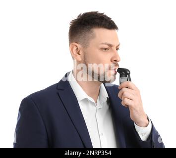 Man blowing into breathalyzer on white background Stock Photo