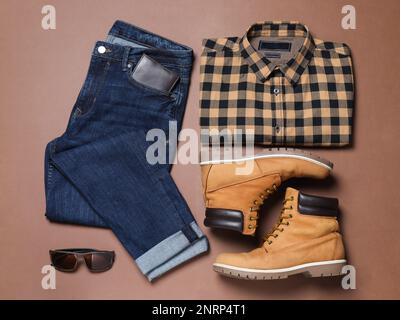 Flat lay composition with stylish men's clothes and boots on brown background Stock Photo