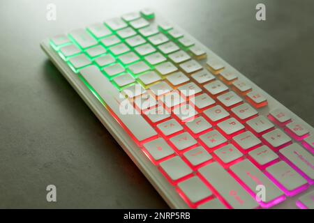 Modern keyboard with RGB lighting on grey table, closeup Stock Photo