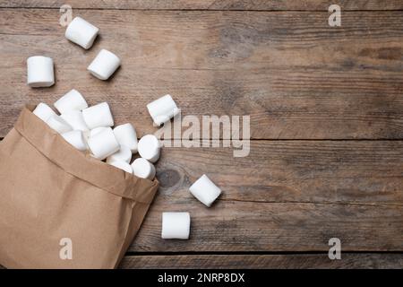 Delicious puffy marshmallows on wooden table, flat lay. Space for text Stock Photo