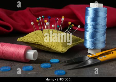 Set of sewing supplies and accessories on grey stone table Stock Photo