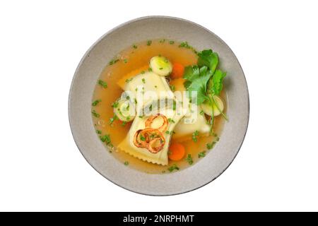 Delicious soup with Swabian ravioli topped with roasted onion rings and served in a grey ceramic bowl isolated on white background Stock Photo