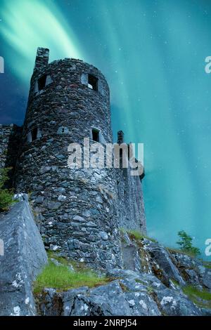 The kilchurn castle ruin on the banks of Loch Awe in the Highlands of Scotland. This mock up shows a possible aurora over the ruins. Stock Photo