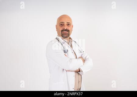 Portrait of caucasian posing doctor. Crossed arms smiling and confident. Looking camera. Copy space. Wearing hospital professional uniform. Stock Photo