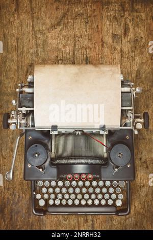Top view of a vintage typewriter with empty sheet of paper Stock Photo